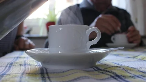 Elderly couple having a hot cup of coffee at home Stock Footage 290982204