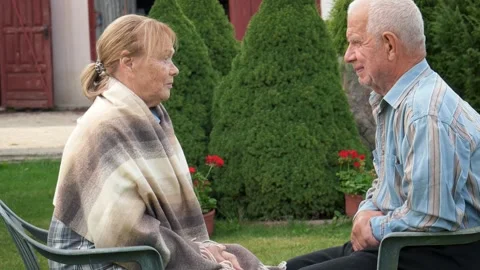 Elderly couple having talking in green garden Stock Footage 288372263