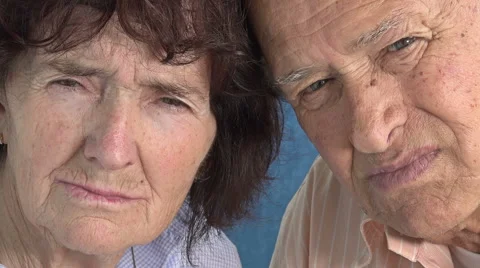 Elderly couple looking in the camera: closeup portrait Stock Footage 64302045