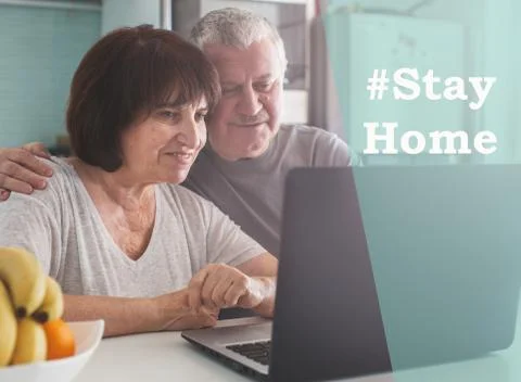 Elderly couple looking at computer during the pandemic coronavirus Stock Photos
