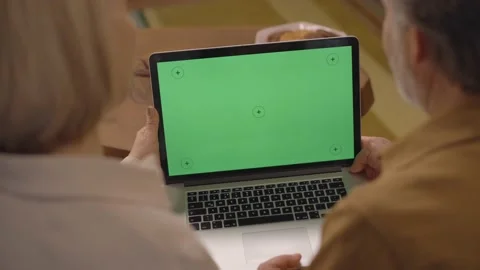 Elderly couple is looking at the computer screen with green tracking markers. 스톡 동영상 148682078
