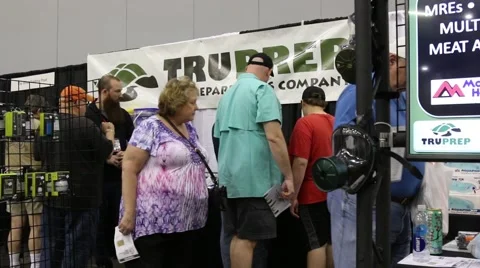Elderly Couple Looking at Prepper Display at Trade Show Stock Footage 64906933
