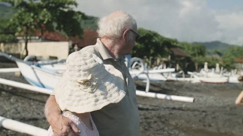 Elderly couple looking at the running girl Stock Footage