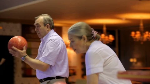 Elderly couple plays bowling Stock Footage 100241597