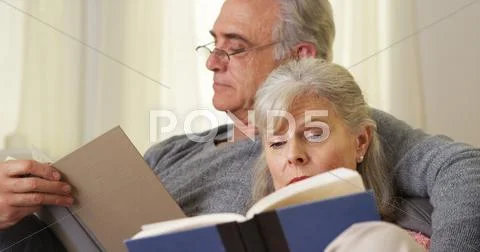 Elderly Couple Reading Books