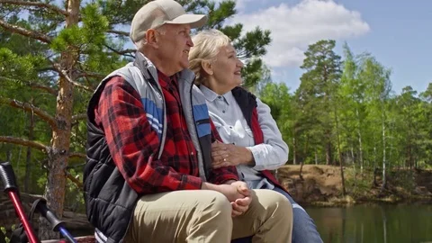 Elderly Couple Resting on Park Bench Stock Footage
