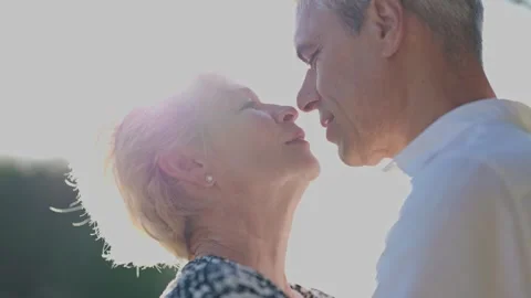 Elderly couple sharing a tender moment outdoors Stock Footage 309553441