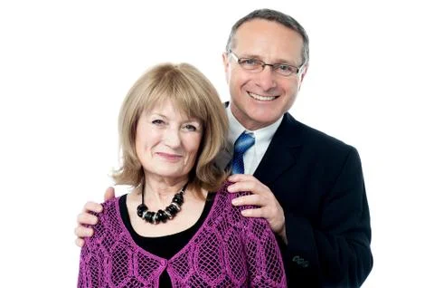 Elderly couple smiling to the camera Stock Photos