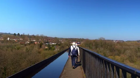 An elderly couple walking across the famous Pontcysyllte Aqueduct Stock Footage 106410153