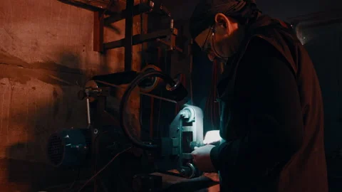 Elderly Craftsman sharpening a blade Stock Footage 275448642