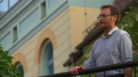 An Elderly Dark-Haired Man Left on a Balcony Stock Footage 67553195