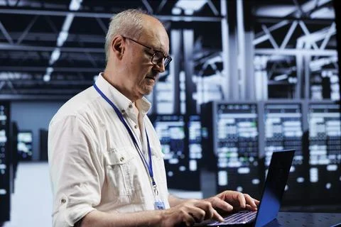 Elderly developer setting up VPN servers Stockfoto's