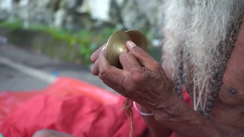Elderly devotee with long beard playing hand bell near Kamakhya Temple Guwahati Stock Footage 339269367