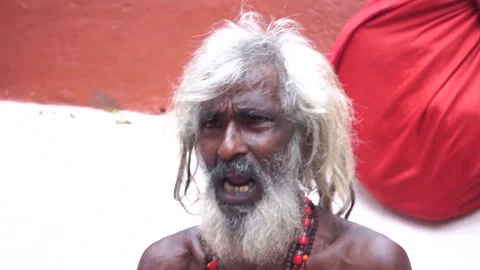 Elderly devotee singing and playing musical instrument near Kamakhya Temple Stock Footage 339269443