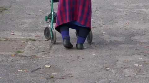 Elderly disabled woman with special walker Stock Footage
