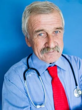 Elderly doctor on blue lab background Stock Photos