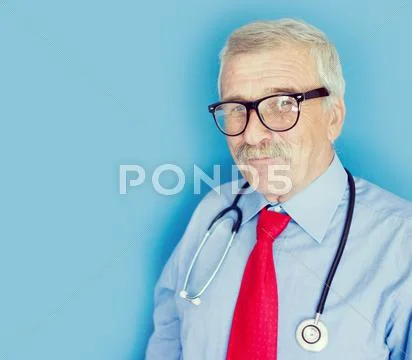Elderly Doctor On Blue Lab Background
