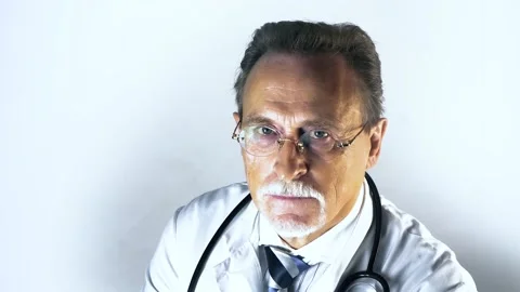 Elderly doctor look at camera Stock Footage 130349439