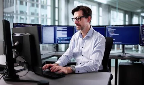 Elderly Engineer Developing Cyber Security Program On Desktop Computer Screen 写真素材