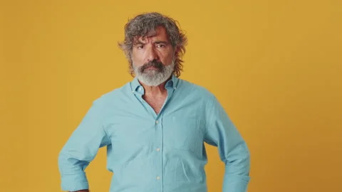 Elderly gray-haired man listens attentively and categorically against, isolated Stock Footage 252503449