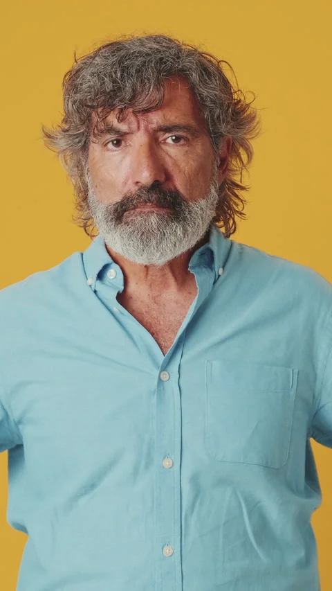Elderly gray-haired man listens attentively and categorically against, isolated Stock Footage 255505206