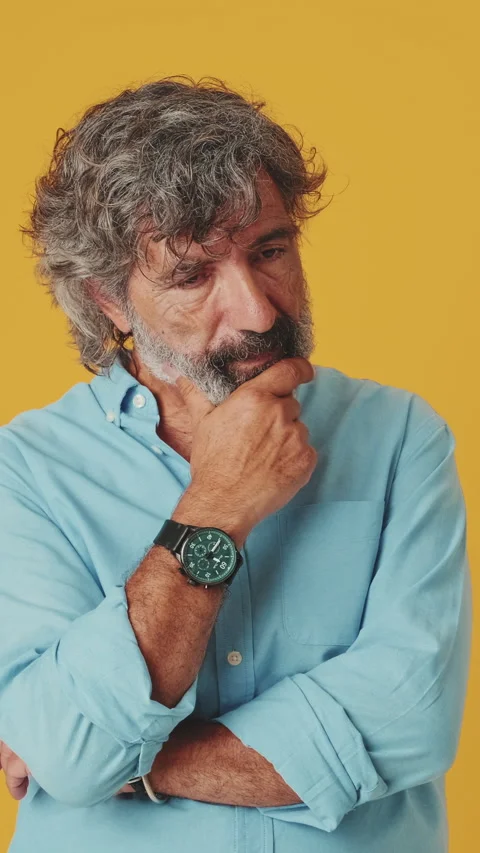 Elderly grey-haired man having doubts, having no idea what to do isolated on Stock Footage 252207490