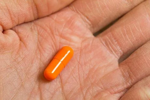 Elderly hand with capsule Stock Photos