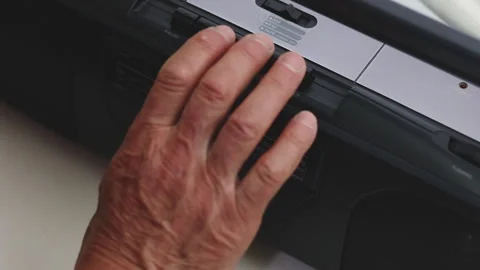 Elderly hand inserting a cassette into a retro stereo, operating a boombox Видео 337189546