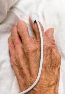 Elderly hand with a pulse meter. Stock Photos