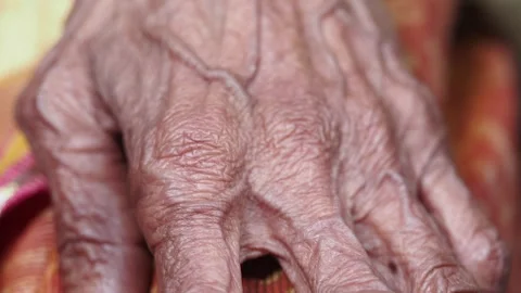 Elderly hand showcasing fine lines and wisdom in close-up Stock Footage 307596467