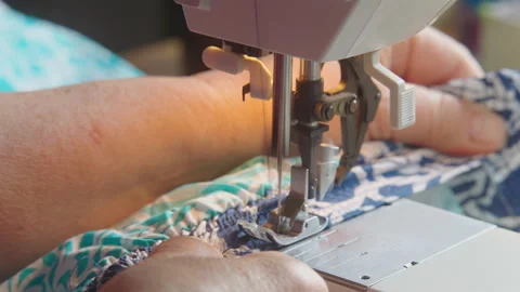 Elderly Hands Stitching Elastic onto Colorful Fabric Stock Footage 336717635
