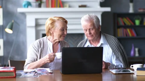 Elderly happy couple working on the computer Stock Footage 63324190