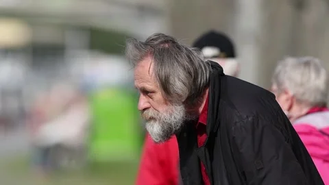 Elderly homeless man searching for something in garbage bin and on city stree Stock Footage 337906904