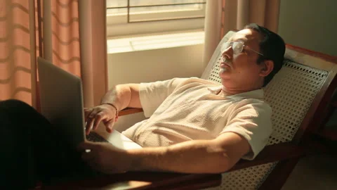 Elderly Indian man using artificial intelligence software for work on a laptop 스톡 동영상 347849721