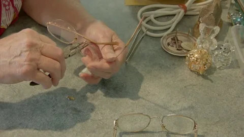Elderly lady adjusts her spectacles Stock Footage 71153359