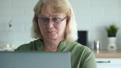 Elderly lady computing white older woman engaged with her digital device Stock Footage 321810525
