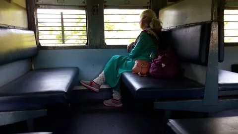 Elderly lady sitting alone inside Indian Railway coach 動画素材 154946814