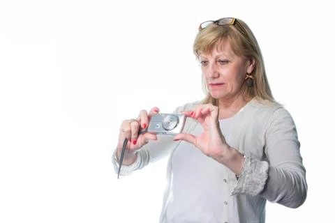 Elderly lady using a compact camera Stock Photos