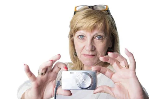 Elderly lady using a compact camera Stock Photos