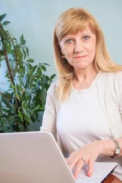 Elderly lady using her personal computer to browse internet Stock Photos