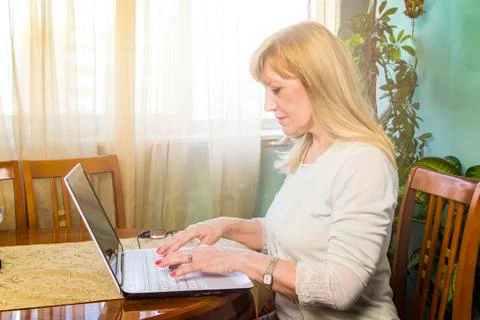 Elderly lady using her personal computer to browse internet Stock Photos