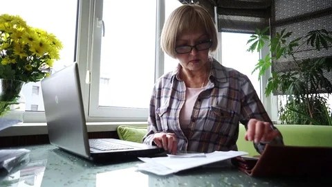 The elderly lady using internet banking in home Stock Footage 75370020