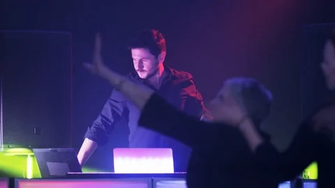 Elderly Lady Waving Her Hands in Front of the DJ Stock Footage 71813809