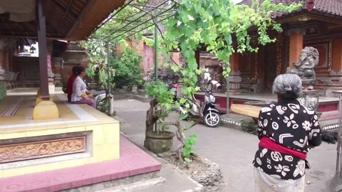 Elderly local Lady preparing the Temple in Bali, Indonesia Stock Footage 131154071