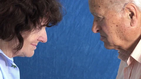 Elderly looking each other, with old woman almost smiling Stock Footage 64303903