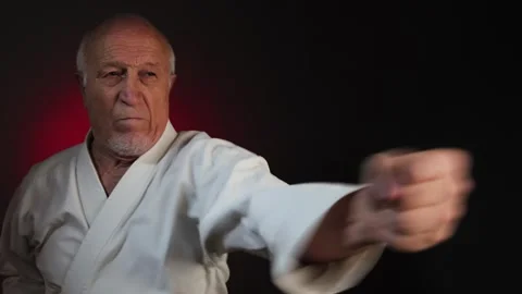 An elderly male athlete performs side punches Stock Footage 341661517