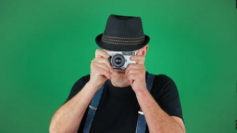 An elderly man, 60 years old, holds an old camera Stock Footage 294830479