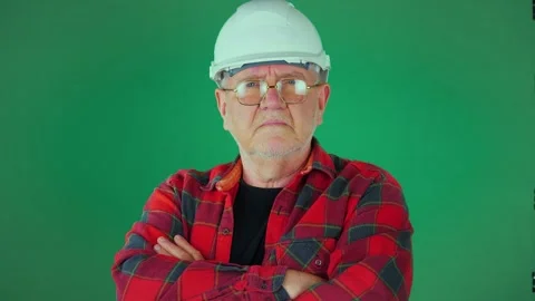An elderly man, 60 years old, in a construction helmet Stock Footage 294830508