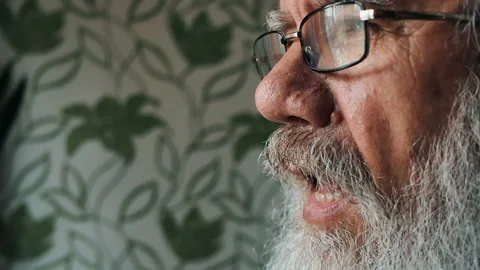 An elderly man with a beard in glasses bites an Apple. Healthy diet Stock Footage 86117323