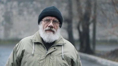 Elderly man with a beard grimaces Stock Footage 83456204